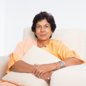 44752445 - portrait of a tired 50s indian mature woman resting on sofa at home. indoor senior people living lifestyle.