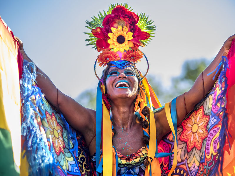 Rio de Janeiro - 55334588 - beautiful brazilian woman of african descent wearing colourful costume and smiling during 2016 carnival street parade in rio de janeiro, brazil