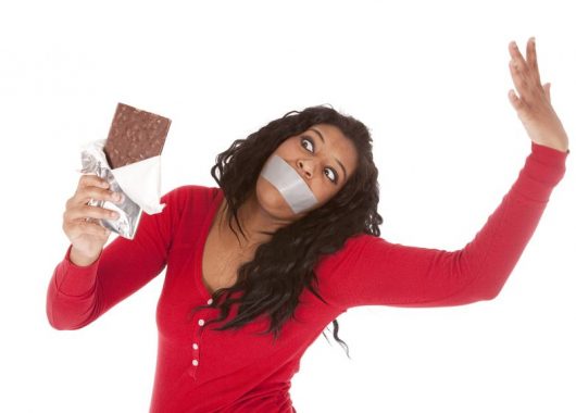 Five things you might want to consider giving up for Lent 9000876 - an african american woman wants to eat some chocolate.