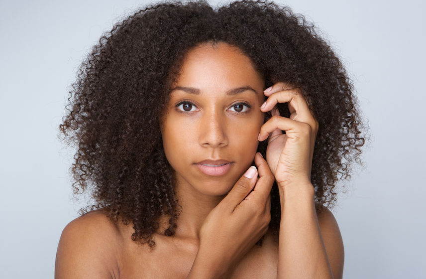 38346904 - close up portrait of an african beauty woman with curly hair posing with hands by face - Natural hair movement drives sales of shampoo skyward 