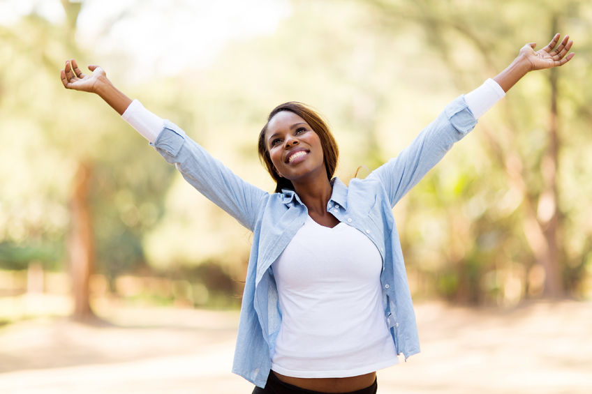 30685346 - happy african woman with arms outstretched outdoors How to silence that negative voice in your head!