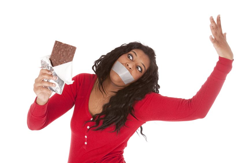 Five things you might want to consider giving up for Lent 9000876 - an african american woman wants to eat some chocolate.