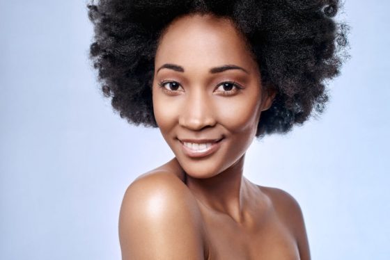 45972216 - portrait of beautiful black african model smiling in studio with smooth complexion flawless skin 10 simple tips to help you grow healthy Afro natural hair