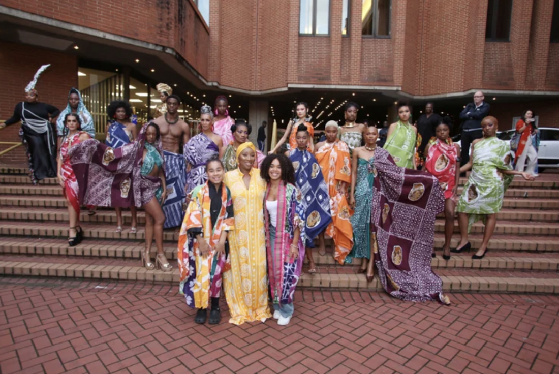 Queen Ronke Ademiluyi-Ogunwusi outside Kensington Town Hall with models featuring Adire textiles